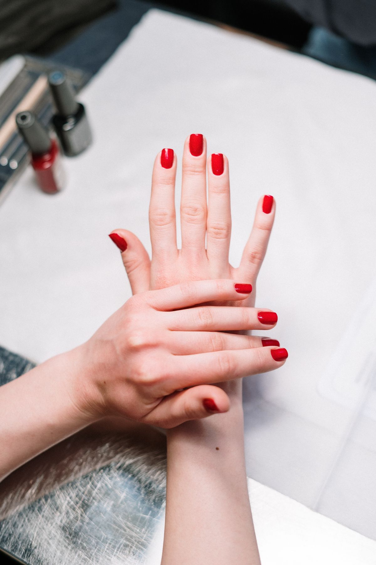 Fresh red manicure, hands close up