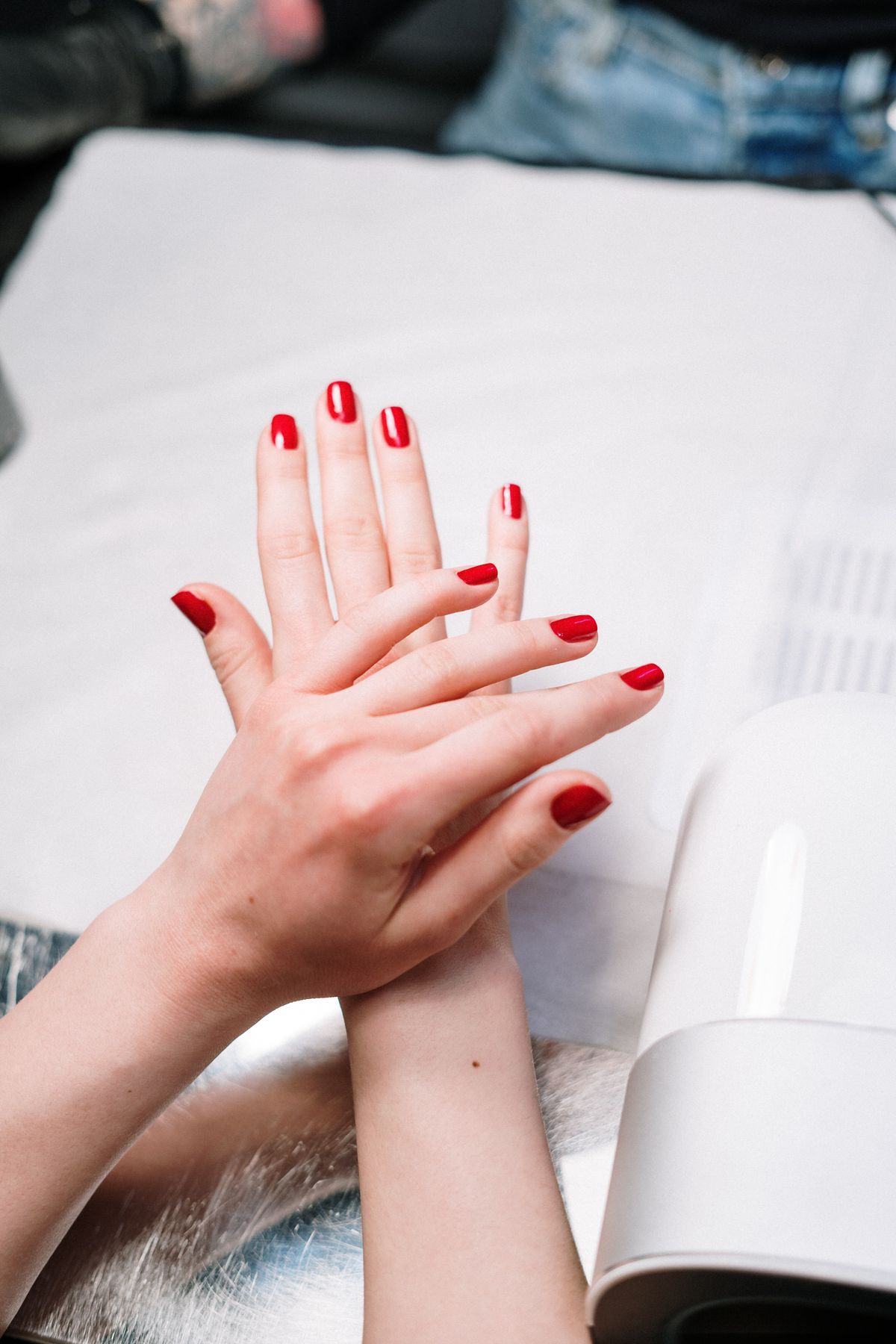 Red gel manicure detail on both hands