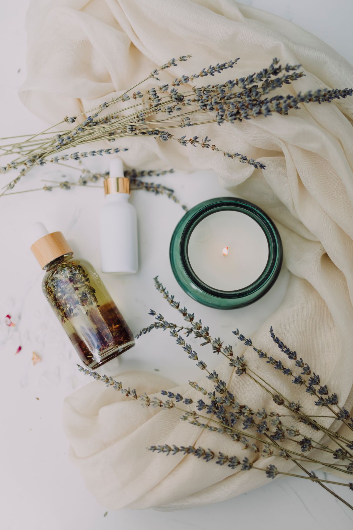 Calm spa ambiance with candle and botanicals